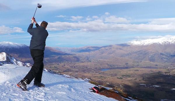Coronet Peak Ski Area Manager Ross Copland teeing off from Coronet Peak looking towards The Hills golf course in the valley below.